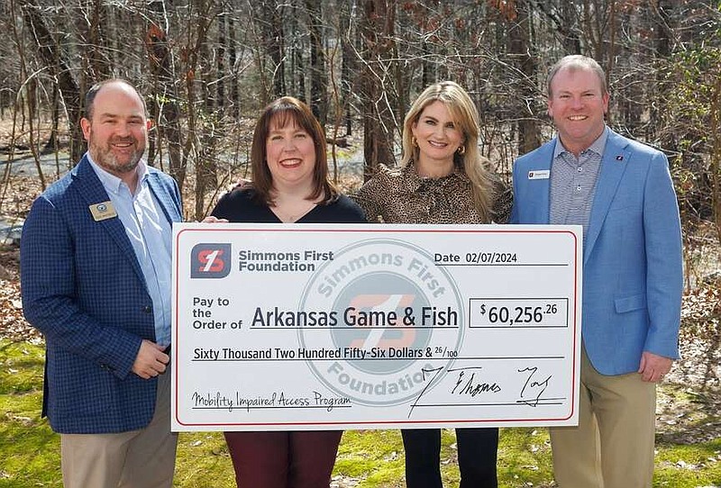 Deke Whitbeck (left) Arkansas Game and Fish Foundation president, Shannon Morgan with the Simmons Foundation, AGFF Director of Development and Corporate Partnerships Jibbie Tyler, and Simmons Bank Division President Reggie Rose celebrate the start of a new partnership to bring more mobility-impaired individuals outdoors. (Special to The Commercial/Arkansas Game and Fish Commission)