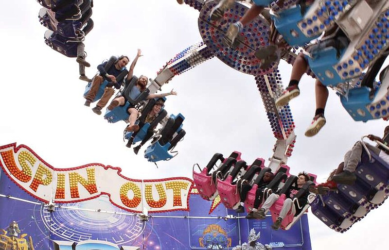 Fairgoers get into the swing of things on the Spin Out on Sunday afternoon, April 2, 2023, during the 78th Four States Fair & Rodeo in Texarkana, Ark. The 79th annual fair beings Friday, April 5, 2024. (Staff file photo by Stevon Gamble)