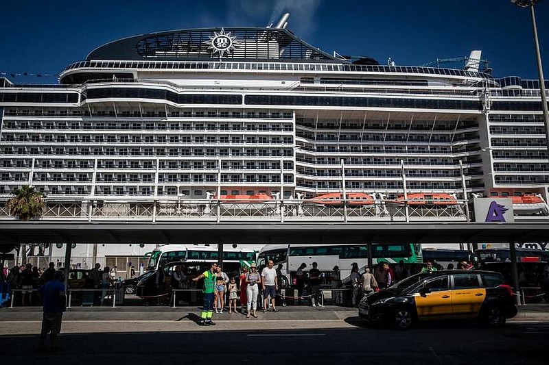 Tourists queue for onward travel at a cruise terminal in Barcelona. MUST CREDIT: Angel Garcia/Bloomberg.