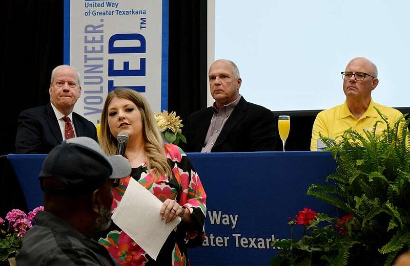 Molly Riley, United Way's vice president of marketing and fundraising, introduces the United Way's partnering agencies attending the 2024 Campaign Recognition Breakfast on Friday morning, March 22, 2024, at Texarkana Convention Center in Texarkana, Texas. Lookin on are, from left, William Morris, treasurer of the United Way Board of Directors; Mayor Allen Brown of Texarkana, Arkansas; and Mayor Bob Bruggeman of Texarkana, Texas. (Staff photo by Stevon Gamble)