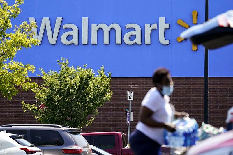 A shopper loads items into her car in the parking lot of a Walmart in Willow Grove, Pa., Wednesday, May 19, 2021. (AP Photo/Matt Rourke)
