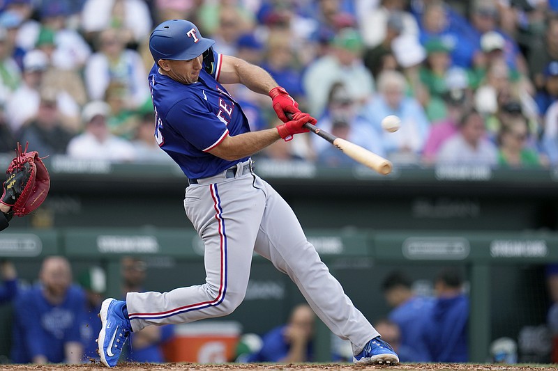 Texas Rangers' Wyatt Langford connects for a run-scoring single against the Chicago Cubs during the fourth inning of a spring training baseball game Sunday, March 17, 2024, in Mesa, Ariz. (AP Photo/Ross D. Franklin)