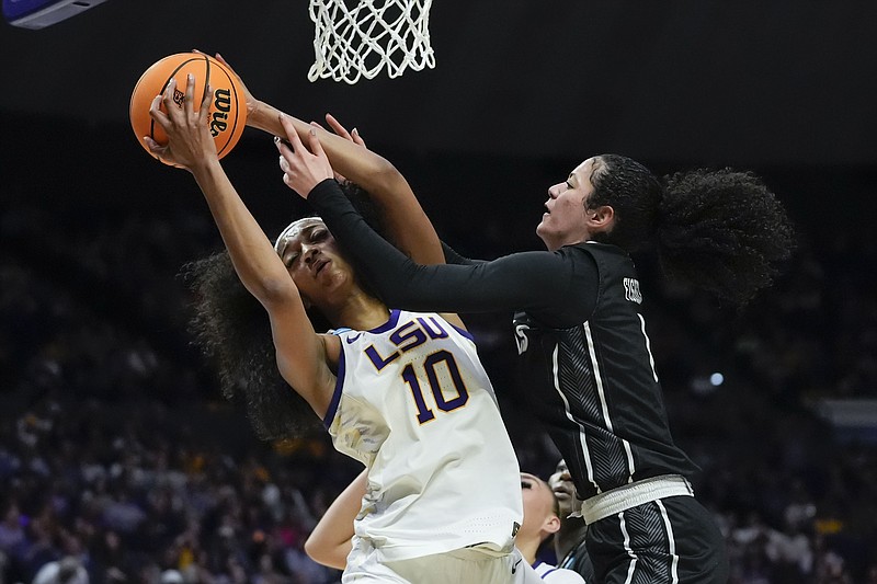 LSU forward Angel Reese (10) battles under the basket with Rice forward Malia Fisher during the second half of a first-round college basketball game in the women's NCAA Tournament in Baton Rouge, La., Friday, March 22, 2024. LSU won 70-60. (AP Photo/Gerald Herbert)