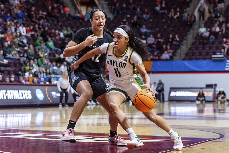 Baylor's Jada Walker drives by Vanderbilt's Khamil Pierre during the first half of a first-round college basketball game in the women's NCAA Tournament in Blacksburg, Va., Friday, March 22, 2024. (AP Photo/Robert Simmons)