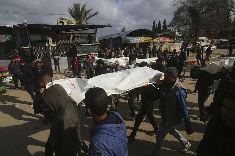 Palestinians carry the bodies of their relatives killed in the Israeli bombardment of the Gaza Strip, during their funeral in Khan Younis, Friday, March 22, 2024. (AP Photo/Hatem Ali)