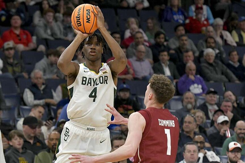 Baylor guard Ja'Kobe Walter (4) shoots over Colgate guard Brady Cummins (1) during the second half of a first-round college basketball game in the NCAA Tournament, Friday, March 22, 2024, in Memphis, Tenn. (AP Photo/Brandon Dill)