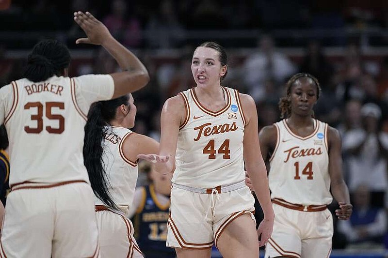 Texas forward Taylor Jones (44) celebrates a score with teammate Madison Booker (35) during the second half of a first-round college basketball game against Drexel in the women's NCAA Tournament in Austin, Texas, Friday, March 22, 2024. (AP Photo/Eric Gay)