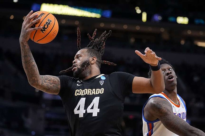 Colorado center Eddie Lampkin Jr. (44) catches a pass in front of Florida forward Tyrese Samuel in the second half of a first-round college basketball game in the NCAA Tournament, Friday, March 22, 2024, in Indianapolis, Ind. (AP Photo/Michael Conroy)