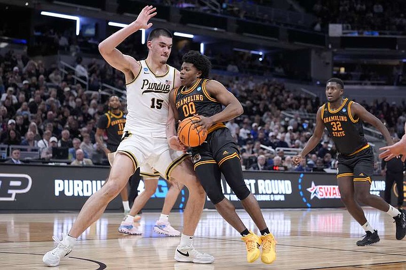 Grambling State guard Kintavious Dozier (00) drives past Purdue center Zach Edey (15) in the first half of a first-round college basketball game in the NCAA Tournament, Friday, March 22, 2024, in Indianapolis. (AP Photo/Michael Conroy)