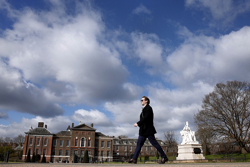A pedestrian passes Kensington Palace in London, Saturday, March 23, 2024. Britain's Kate, Princess of Wales's revelation she is undergoing treatment for cancer has sparked an outpouring of support and well wishes from around the world. (AP Photo/David Cliff)