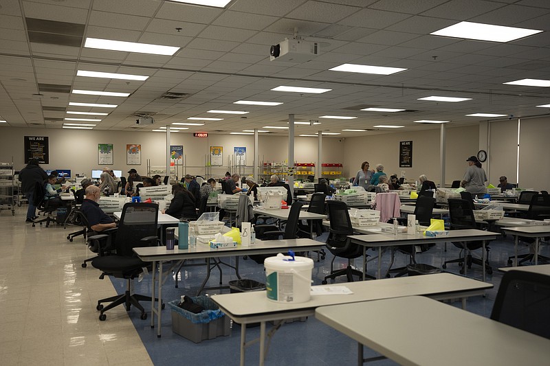 Election officials work on mail ballots at the Maricopa County Tabulation and Election Center in Phoenix, Tuesday, March 5, 2024. (AP Photo/Serkan Gurbuz)