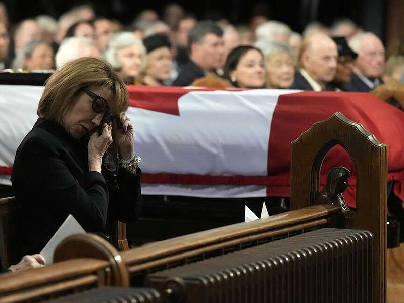 Mila Mulroney, wife of former prime minister Brian Mulroney, wipes away tears as his casket is guided in, during his funeral in Montreal, Saturday, March 23, 2024. (Ryan Remiorz /The Canadian Press via AP)