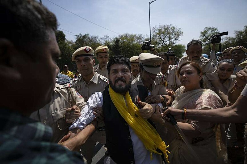 Security personnel detain supporters of Aam Admi Party, or Common Man's Party, during a protest against the arrest of their party leader Arvind Kejriwal, protest against the arrest of their party leader Arvind Kejriwal, in New Delhi, India, Saturday, March 23, 2024. Hundreds of protesters in India's capital took to the streets for a second day Saturday, demanding to the immediate release of one of the Indian Prime Minister Narendra Modi's top rivals, as the country gears up for a national election next month. (AP Photo/Altaf Qadri)