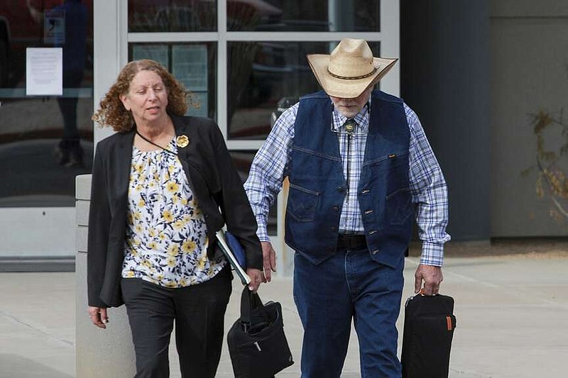 George Alan Kelly, right, exits the Santa Cruz County Courthouse with defense attorney Kathy Lowthorp, Friday, March 22, 2024, in Nogales, Ariz. Rancher Kelly has been charged with second-degree murder in the killing of a man he encountered on his property near Mexico. (Angela Gervasi/Nogales International via AP, Pool)