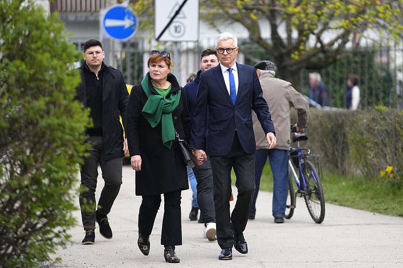 Presidential candidate Ivan Korcok, a pro-Western career diplomat, accompanied by his wife Sona arrives to cast his vote during the first round of the presidential election, in Senec, Slovakia, Saturday, March 23, 2024. (AP Photo/Petr David Josek)