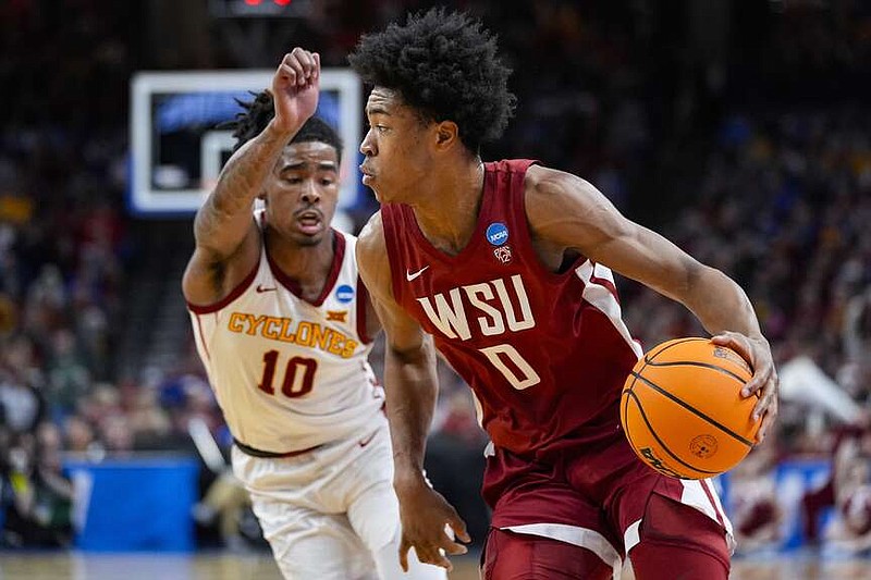 Washington State forward Jaylen Wells (0) drives on Iowa State guard Keshon Gilbert (10) in the first half of a second-round college basketball game in the NCAA Tournament, Saturday, March 23, 2024, in Omaha, Neb. (AP Photo/Charlie Neibergall)