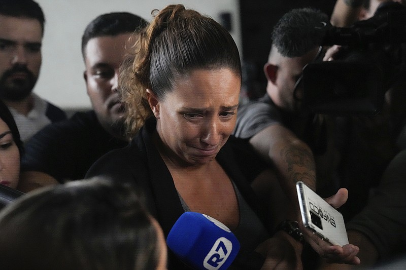Monica Benicio, partner of slain councilwoman Marielle Franco, speaks to journalists at the Federal Police headquarters in Rio de Janeiro, Brazil, Sunday, March 24, 2024. Police arrested on Sunday the men suspected of ordering Franco's killing in 2018. (AP Photo/Silvia Izquierdo)
