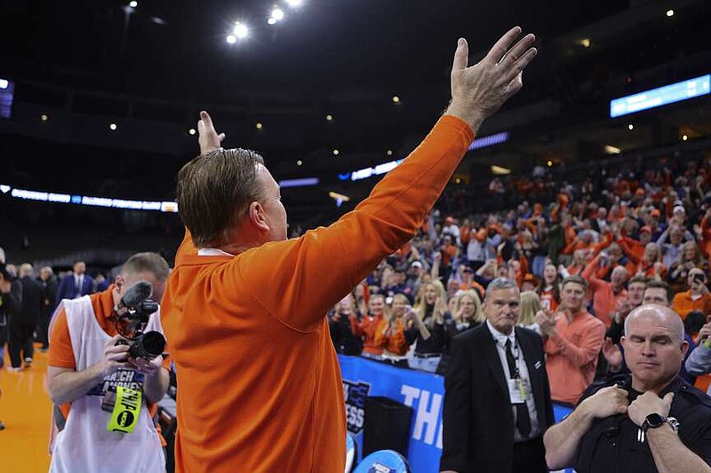 Illinois head coach Brad Underwood celebrates with fans following an 89-63 win over Duquesne in Sunday's second-round game in Omaha, Neb. (AP Photo/John Peterson)