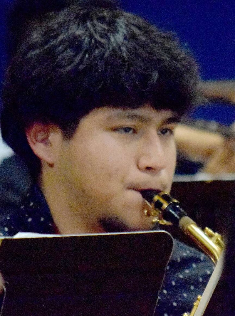 Mike Eckels/Special to the Eagle Observer
Andres Gonzalez plays his saxophone on one of four selections performed by the Decatur High School band during the 2023 Christmas concert in Decatur. After losing his instruments and music when a cargo door on the bus came open, Gonzalez was able to transpose his part from three other instrumental parts and go on to help the band earn excellent ratings at a recent contest.