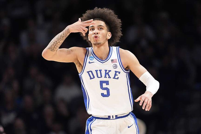 Duke guard Tyrese Proctor blows a kiss to the fans after shooting a 3-point basket during the first half of a second-round college basketball game against James Madison in the NCAA Tournament, Sunday, March 24, 2024, in New York. (AP Photo/Mary Altaffer)