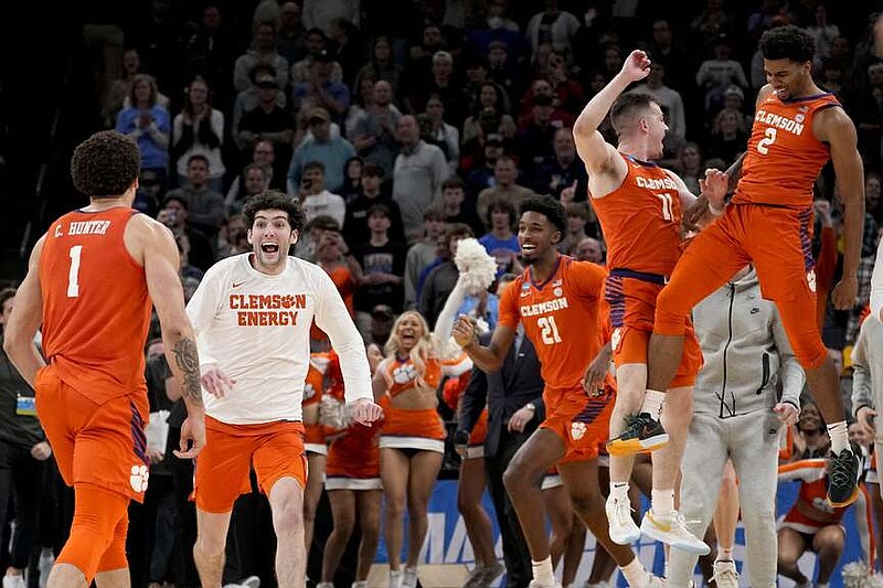 Clemson players celebrate the team's 72-64 win against Baylor after a second-round college basketball game in the NCAA Tournament, Sunday, March 24, 2024, in Memphis, Tenn. (AP Photo/George Walker IV)