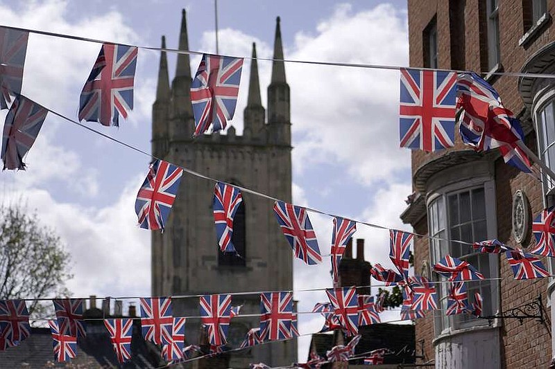 Union Jack flags are decorated in a street in Windsor, England, Saturday, March 23, 2024. Britain's Kate, Princess of Wales's revelation she is undergoing treatment for cancer has sparked an outpouring of support and well wishes from around the world. (AP Photo/Alberto Pezzali)