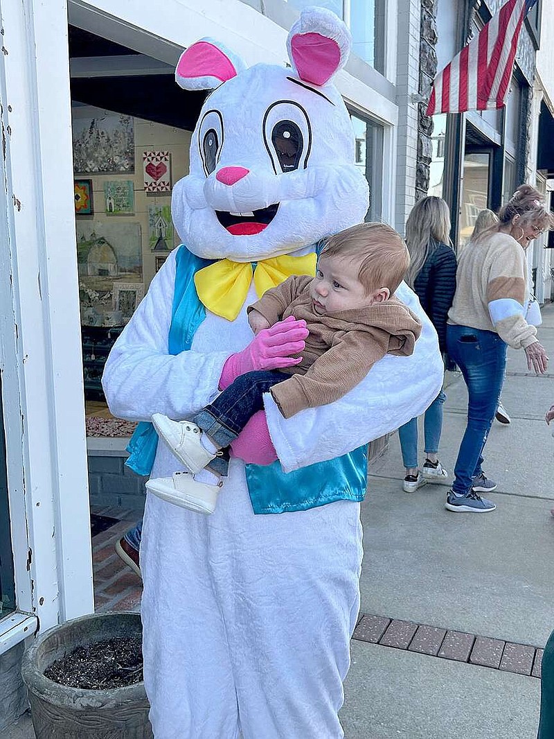 The Easter Bunny got in a few snuggles Saturday for the first Downtown Bunny Hop in Prairie Grove. Here, the bunny is holding Weston Bowden, who was with his mother,  Hailey Kerns, both of Illinois. They were visiting relatives in Northwest Arkansas. Prairie Grove Chamber of Commerce, downtown merchants and Main Street Prairie Grove sponsored the event to bring visitors to shop local stores and celebrate the Easter holiday.