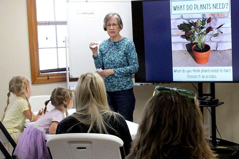 Annette Beard/Pea Ridge TIMES
Master gardener Kim Eveland talks to children about what plants need to grow. She was one of three members of the Benton County Master Gardeners who taught gardening to children Tuesday, March 19, 2024, at the Pea Ridge Community Library. Others were Candy Alfano and Brenda Harmon. For more photographs, go to the PRT gallery at https://tnebc.nwaonline.com/photos/.