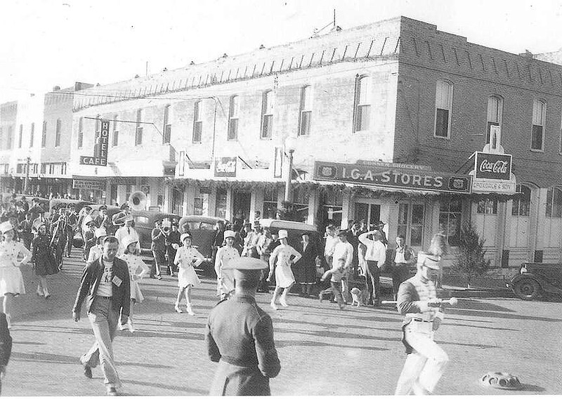 A parade down First Street about 1940. Croxdale's Grocery is on the corner of First and Elm Streets. The building that housed Croxdales was one of the first masonry buildings in Rogers, The Commercial Hotel, built in 1885.

(Courtesy of the Rogers Historical Museum)
