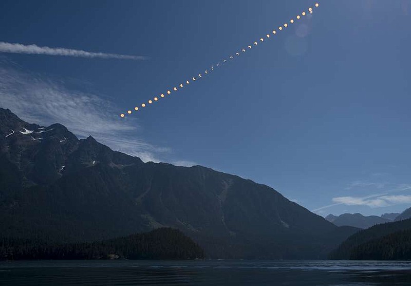 This composite image shows the progression of a partial solar eclipse over Ross Lake, in Northern Cascades National Park, Washington on Monday, Aug. 21, 2017. A total solar eclipse swept across a narrow portion of the contiguous United States from Lincoln Beach, Oregon to Charleston, South Carolina. A partial solar eclipse was visible across the entire North American continent along with parts of South America, Africa, and Europe. (NASA/Bill Ingalls)