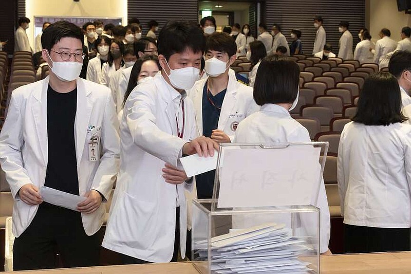 Medical professors queue to submit their resignations during a meeting at Korea University in Seoul, South Korea, Monday, March 25, 2024. Senior doctors at dozens of hospitals in South Korea planned to submit their resignations Monday in support of medical interns and residents who have been on a strike for five weeks over the government's push to sharply increase medical school admissions, their leader said.(Yoon Dong-jin/Yonhap via AP)