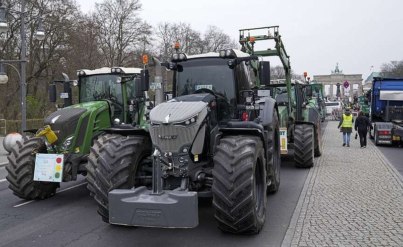 Farmers block a street with their tractors at the Brandenburg Gate during a Farmer's protest in Berlin, Germany, Friday, March 22, 2024. (AP Photo/Ebrahim Noroozi)