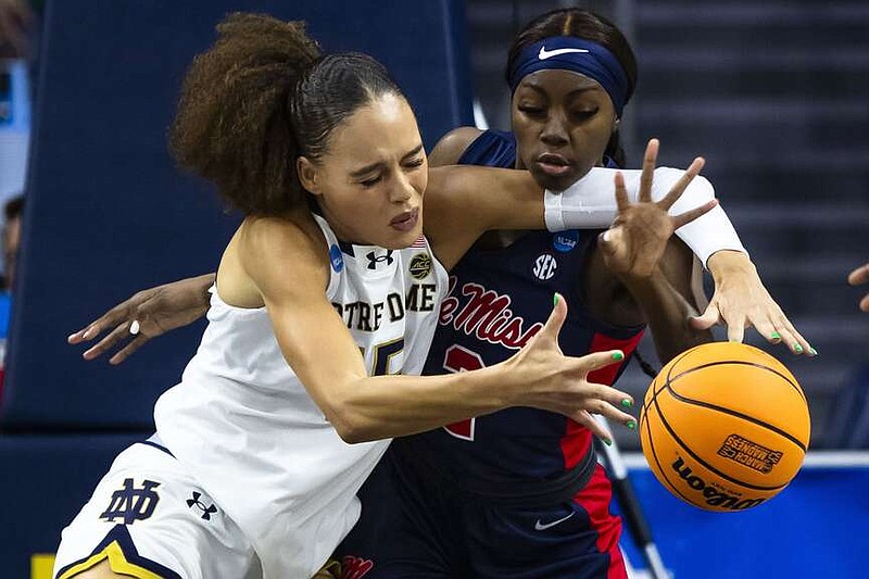 Notre Dame forward Natalija Marshall (15) and Mississippi guard Marquesha Davis (2) fight for a loose ball during the first half of a second-round college basketball game in the NCAA Tournament Monday, March 25, 2024, in South Bend, Ind. (AP Photo/Michael Caterina)