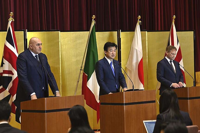 FILE - Britain's Defense Minister Grant Shapps, right, Italy's Defense Minister Guido Crosetto, left, and Japanese Defense Minister Minoru Kihara, center, attend a joint press conference after a signing ceremony for Global Combat Air Programme (GCAP) at the defense ministry on Dec. 14, 2023, in Tokyo, Japan. Japan's Cabinet on Tuesday, March 26, 2024, approved a plan to sell future next-generation fighter jets that it's developing with Britain and Italy to other countries, in the latest move away from the country's postwar pacifist principles. (David Mareuil/Pool Photo via AP, File)