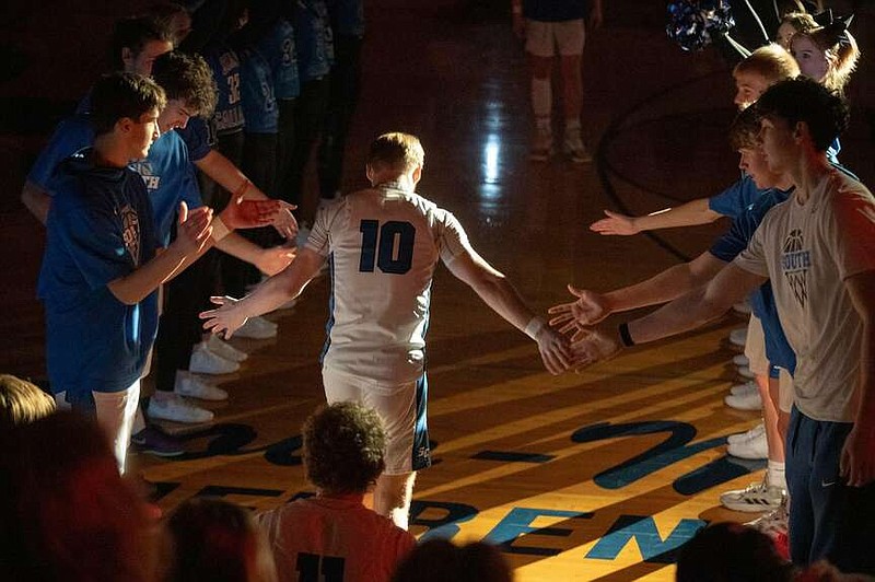 South Callaway's Tayber Gray shakes his teammate's hands during the lineup introduction for a game at South Callaway High School in Mokane. (SC Boys Basketball/Courtesy)