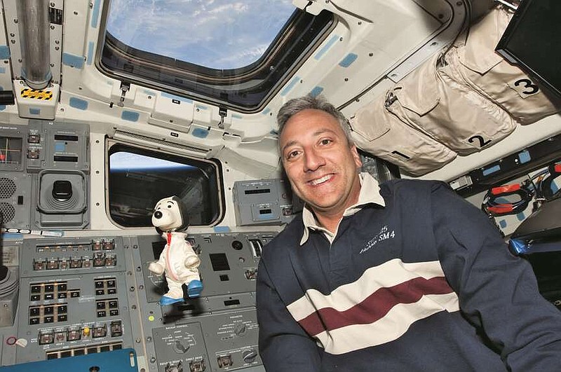 Astronaut Mike Massimino took the Snoopy from his boyhood into space in 2009. MUST CREDIT: NASA