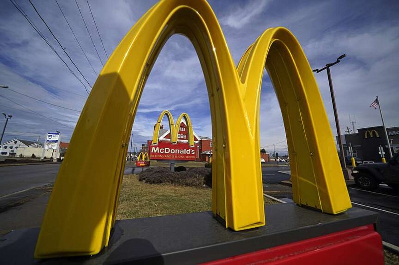 FILE - McDonald's restaurant signs are shown in in East Palestine, Ohio, Feb. 9, 2023. Krispy Kreme stock jumped Tuesday, March 26, 2024, after it announced a deal where McDonald's restaurants will sell its doughnuts across the country.(AP Photo/Gene J. Puskar, File)