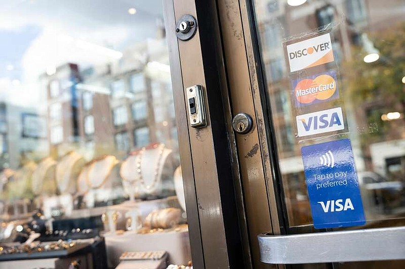 A sticker for Mastercard, and Visa credit cards in New York. MUST CREDIT: Angus Mordant/Bloomberg.