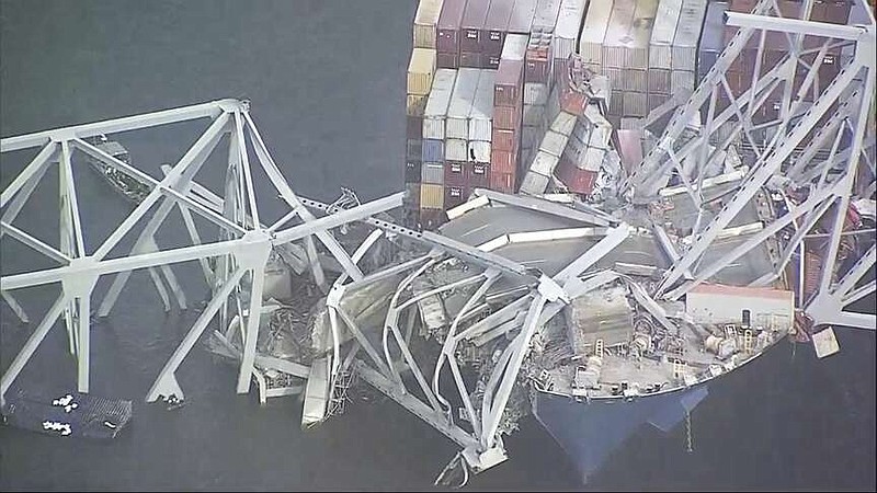 Parts of the Francis Scott Key Bridge remain after a container ship collided with one of the bridges support Tuesday, March 26, 2024 in Baltimore. The major bridge in Baltimore snapped and collapsed after a container ship rammed into it early Tuesday, and several vehicles fell into the river below. Rescuers were searching for multiple people in the water.  (WJLA via AP)