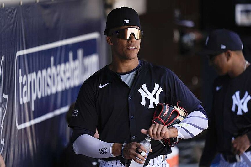 New York Yankees right fielder Juan Soto stands in the dugout before a spring training baseball game against the Boston Red Sox Wednesday, March 13, 2024, in Tampa, Fla. (AP Photo/Charlie Neibergall)