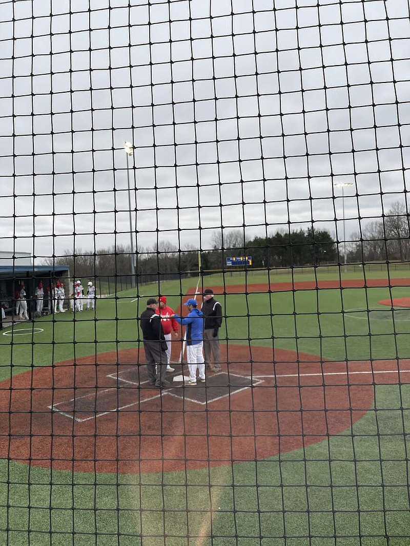 South Callaway coach Mason Mershon meets with Linn coach Dan Campbell and the umpires at home plate before the Bulldogs' Show-Me Conference opener Tuesday at South Callaway's baseball field in Mokane. (Robby Campbell/Fulton Sun)