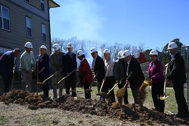 Officials break ground on National Park College's Redbud Hall, which will open for student living in the summer of 2025, on the campus Wednesday. (The Sentinel-Record/Lance Brownfield)
