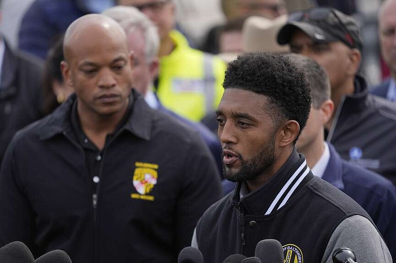 Baltimore Mayor Brandon Scott, accompanied by Maryland Gov. Wes Moore, speaks during a news conference near the scene where a container ship collided with a support on the Francis Scott Key Bridge, in Dundalk, Md., Tuesday, March 26, 2024. (AP Photo/Matt Rourke)