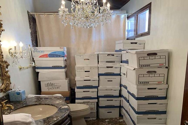 This image, contained in the indictment against former President Donald Trump, shows boxes of records stored in a bathroom and shower in the Lake Room at Trump's Mar-a-Lago estate in Palm Beach, Fla. The classified documents investigation of Donald Trump appeared to have clear momentum in 2022 when FBI agents who searched the former president's Mar-a-Lago estate recovered dozens of boxes containing sensitive documents. But each passing day brings mounting doubts that the case can reach trial this year. The judge has yet to set a firm trial date despite holding two hours-long hearings with lawyers this month. (Justice Department via AP)