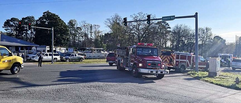 Arkansas State Police, left, direct traffic as Morning Star Fire Department and LifeNet personnel work the scene of a two-vehicle wreck that occurred shortly after 8 a.m. Thursday at the intersection of Malvern Avenue and Akers Road. (The Sentinel-Record/James Leigh)