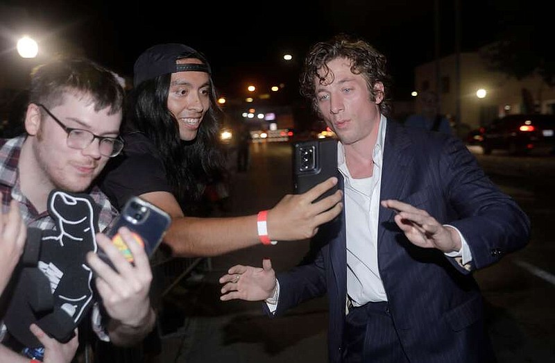 Actor Jeremy Allen White takes photos with fans as he arrives to the red carpet for the world premiere of "The Iron Claw" at the Texas Theatre in Dallas on Nov. 8, 2023. (Tom Fox/The Dallas Morning News/TNS)