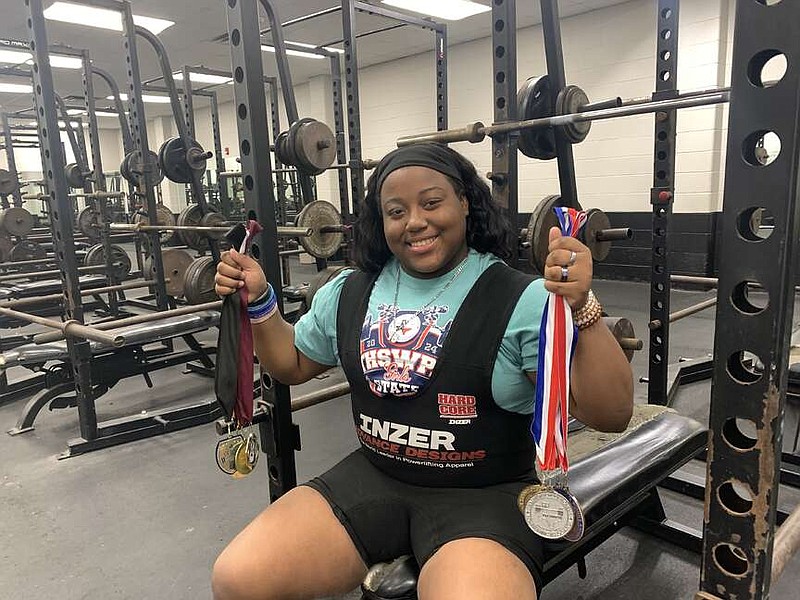 DeKalb, Texas, High School sophomore Talisha Ingram won first place at the 2024 Girls State Powerlifting Competition. Ingram holds up the eight medals that she has won from previous powerlifting competitions, at DeKalb High School on Wednesday, March 27, 2024. (Staff photo by Mallory Wyatt)