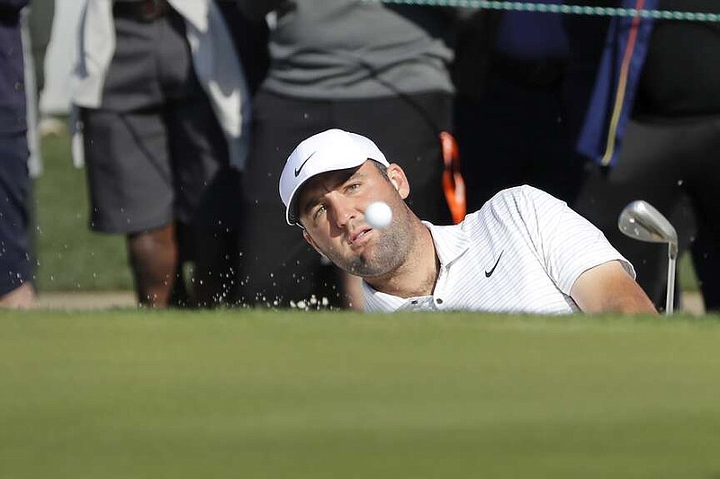 Scottie Scheffler hits out of the bunker on the 18th green during the first round of the Houston Open Thursday in Houston. (AP Photo/Michael Wyke)