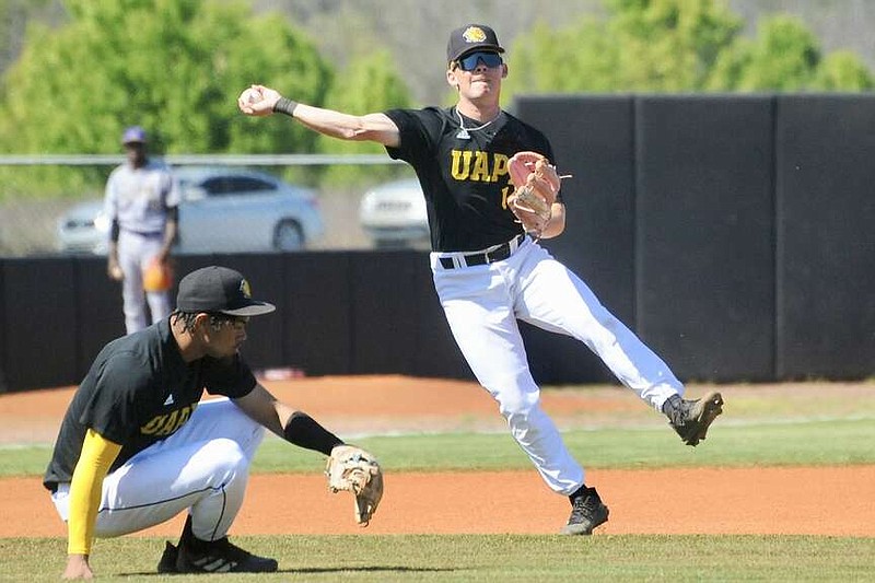 UAPB sophomore shortstop Trinidad De La Garza throws the ball as junior third baseman Jaylon Nauden ducks during Thursday's baseball game against Alcorn State at the Torii Hunter Baseball Complex in Pine Bluff. (Special to the Commercial/William Harvey)