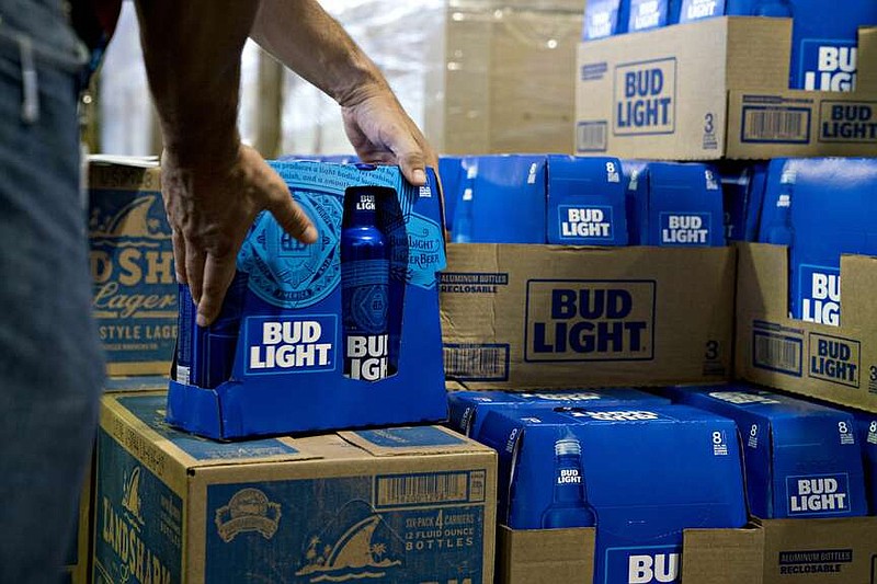 An employee adjusts bottles of Bud Light brand beer at an Anheuser-Busch InBev NV facility in Williamsburg, Virginia, U.S., on Wednesday, Aug. 8, 2018. MUST CREDIT: Andrew Harrer/Bloomberg